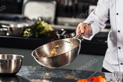 Preview: Chef Hand Keep Wok. Closeup Hands Tossing Food At Professional Kitchen. Chef In Uniform Prepare