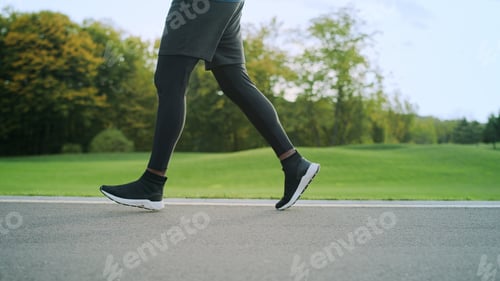 Preview: Close Up Athlete In Sports Shoes Jogging On Road. Man Legs Training Outdoors In Slow Motion. Male