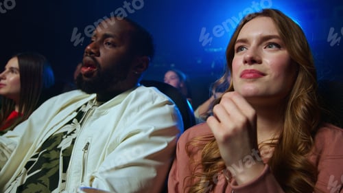 Preview: Cheerful Multi Ethnic People Having Fun In Dark Hall. Joyful African Man And Caucasian Woman Eating