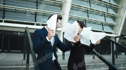 Preview: Happy Couple Throwing Papers In Slow Motion Outdoors. Attractive Business Couple Laughing Together