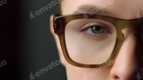 Preview: Macro Of Focused Businesswoman Eye Looking Straight At Camera In Office. Extreme Close Up Of Half