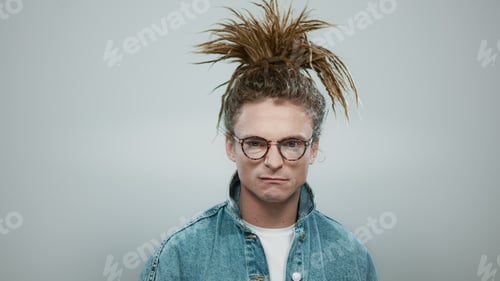 Preview: Portrait Of Angry Man Looking At Camera. Closeup Displeased Guy Standing In Studio. Fashionable Man