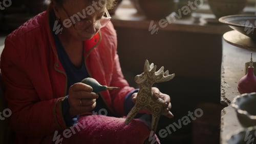 Preview: Closeup Elderly Woman Decorating Clay Toy In Studio. Portrait Of Senior Ceramist Making Ornament On