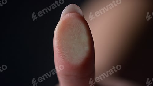 Preview: Marco Of Female Fingerprint On Glass Surface Indoors. Manicured Finger Pressing Glassware On Black