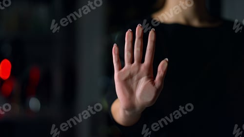 Preview: Close Up Of Female Hand Touching Glass Wall Indoors. Young Woman Holding Hand On Glass Surface