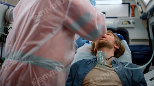 Preview: Emergency Doctors Taking Nasophargeal Swab Of Patient For Coronavirus Sample In Emergency Car