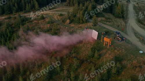 Preview: Mountain Movie Shooting Team Aerial View With Smoke Screen Green Trees Growing. Drone Scene Group