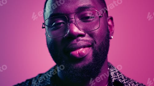 Preview: Closeup Affectionate Afro Guy Looking At Camera Indoors. Portrait Of Fancy Male Person Staring At