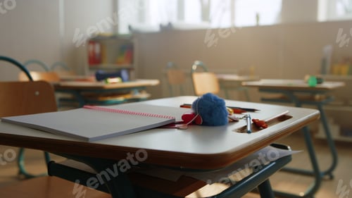 Preview: Open Notebook And Pencils Lying On School Desk In Classroom. Wooden Table With School Supplies In
