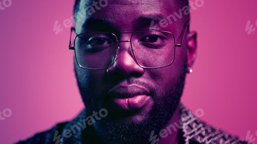 Preview: Closeup African American Man Raising Head Up Indoors. Portrait Of Cute Afro Guy Looking At Camera