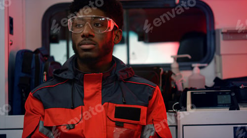Preview: Ems Paramedic Driving In Ambulance Vehicle For 911 Call. Male African American Medic Feeling Tired