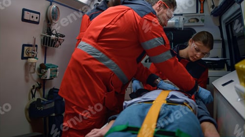 Preview: Rescue Team Of Paramedics Giving First Aid Help To Victim In Emergency Car. Mixed Race Medical