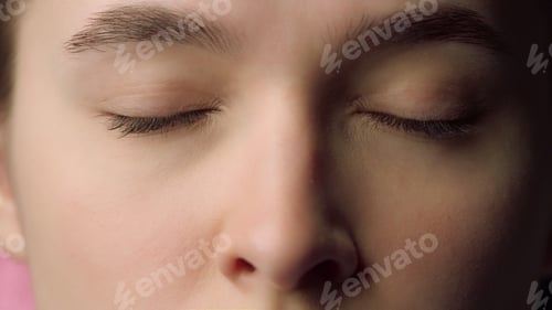 Preview: Closeup Beautiful Female Face With Closed Eyes. Serious Young Woman Face With Natural Features