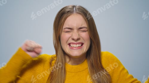 Preview: Portrait Of Positive Woman Enjoying Victory At Camera. Closeup Excited Girl Laughing In Studio