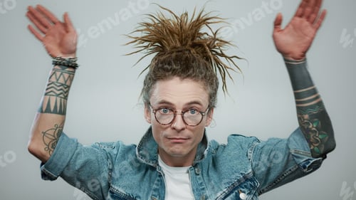 Preview: Portrait Of Cheerful Man Making Funny Faces At Camera In Studio. Positive Guy Having Fun. Male
