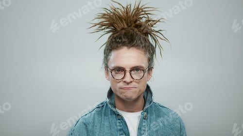 Preview: Closeup Stylish Man Standing In Studio. Crazy Guy Showing Heavy Metal Gesture. Portrait Of Excited