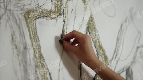 Preview: Closeup Woman Hand Drawing With Black Chalk On Canvas In Art Studio. Unrecognizable Painter