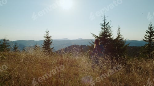 Preview: Serious Woman Hiking In Mountains During Weekend. Focused Girl Exploring Nature. Female Hiker