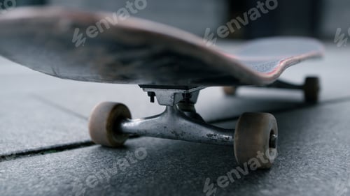 Preview: Closeup Skate Wheels On Grey Sidewalk. Bottom View Of Skate Board Staying Outside In Summer