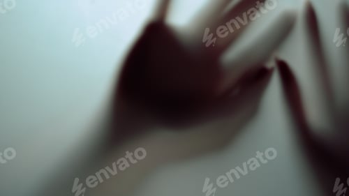 Preview: Female Clenching Fists Showing Ten Fingers Behind Frosty Glass. Macro Video Of Silhouette Woman
