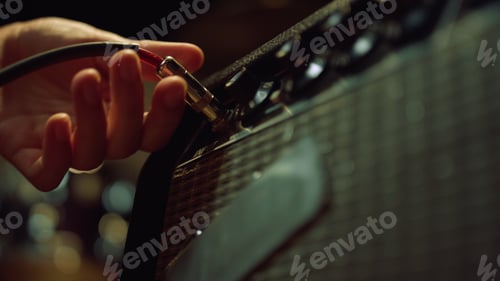 Preview: Macro Man Hand Sticking Plug To Control Desk In Concert Hall. Sound Engineer Preparing Instrument