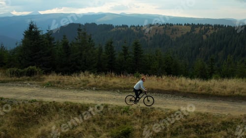 Preview: Mountain Cycling Drone View Against Stunning Spruce Forest Hills Enjoying Time. Tranquil Scene