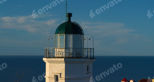 Preview: Closeup Sea Lighthouse Aerial View At Sunset. Drone View Nautical Beacon At Coastline At Blue Sky