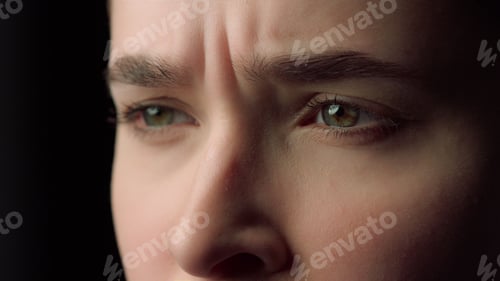 Preview: Macro Of Sad Woman Face Watching Unpleasant Video Indoors. Serious Girl Expressing Negative Emotion