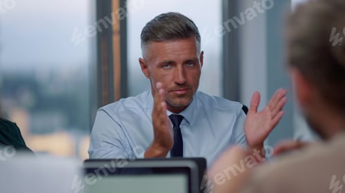 Preview: Serious Businessman Having Meeting With Clients In Office. Male Executive Discussing Terms Of