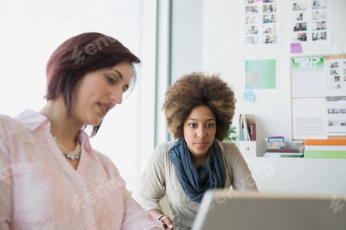 Preview: Businesswomen Working At Laptop In Office