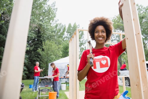 Preview: Portrait Of Confident Volunteer At Construction Frame