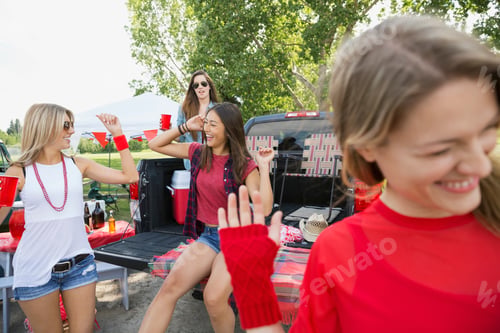 Preview: Women Cheering At Tailgate Barbecue In Field