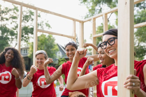 Preview: Female Volunteers Flexing Muscles At Construction Frame