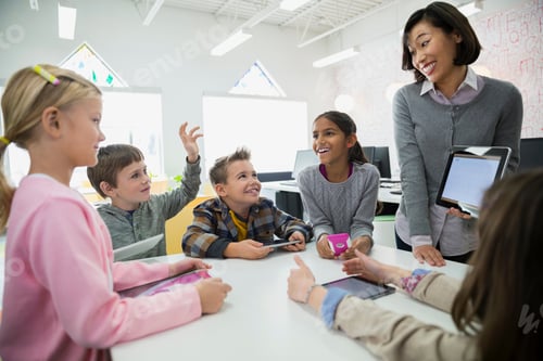 Preview: Teacher And Elementary Students With Digital Tablet