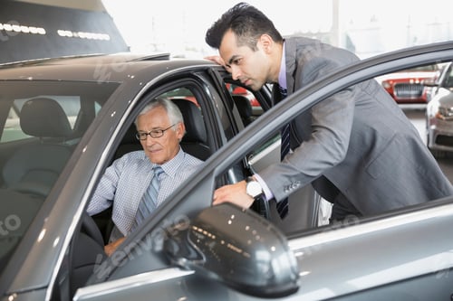 Preview: Salesman And Man Looking Inside Car In Showroom
