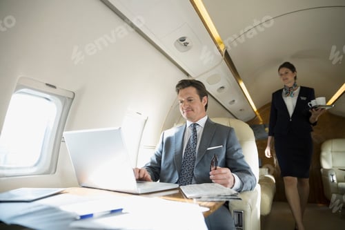 Preview: Flight Attendant Approaching Businessman On Corporate Jet