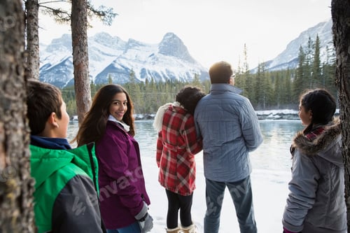 Preview: Family Looking At Snowy Mountains At Riverside