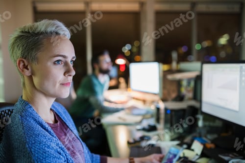 Preview: Business People Working Late At Computers In Office