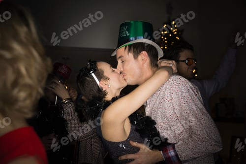 Preview: Couple Kissing At New Years Eve Party