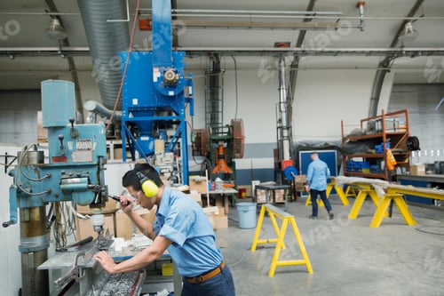 Preview: Worker Operating Drill Machinery In Manufacturing Plant