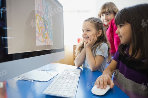 Preview: Smiling Girls Drawing On Computer In School