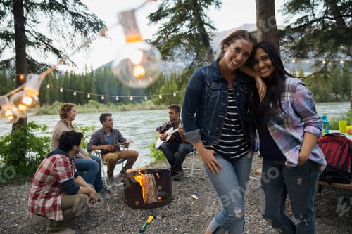 Preview: Friends Hanging Out Around Campfire At Campsite