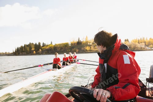 Preview: Coach Watching Rowing Team On Sunny River