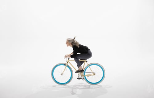 Preview: Woman Riding Bicycle Against White Background