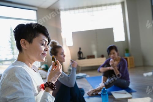 Preview: Women Smelling Essential Oil At Yoga Retreat