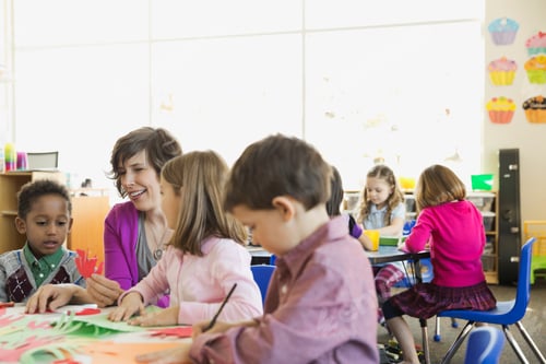 Preview: Smiling Teacher With Students In Elementary Class