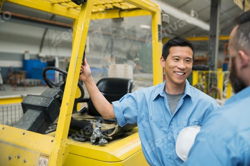 Preview: Workers Talking At Forklift In Factory