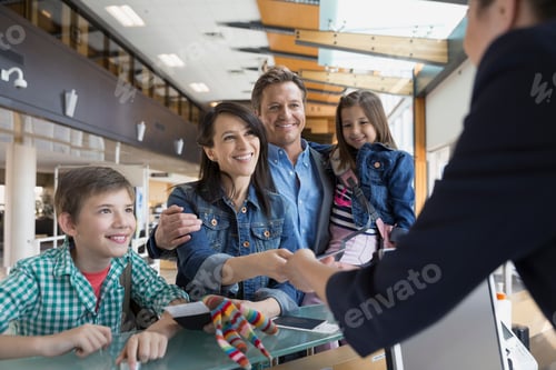 Preview: Family Checking In At Airport Counter