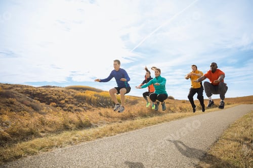 Preview: Fitness Group Jumping On Rural Path