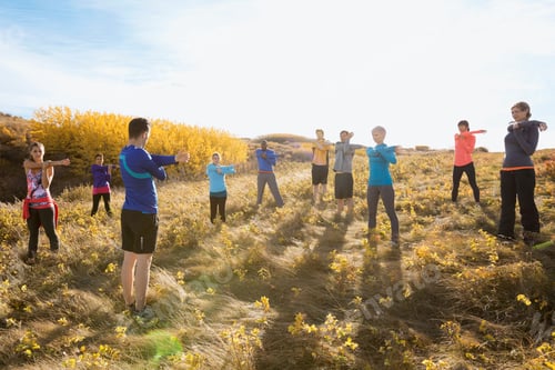 Preview: Group Fitness Stretching In Sunny Rural Field